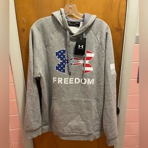 NWT men’s under armor hoodie in grey with “Freedom”w/US flag under armor symbol.